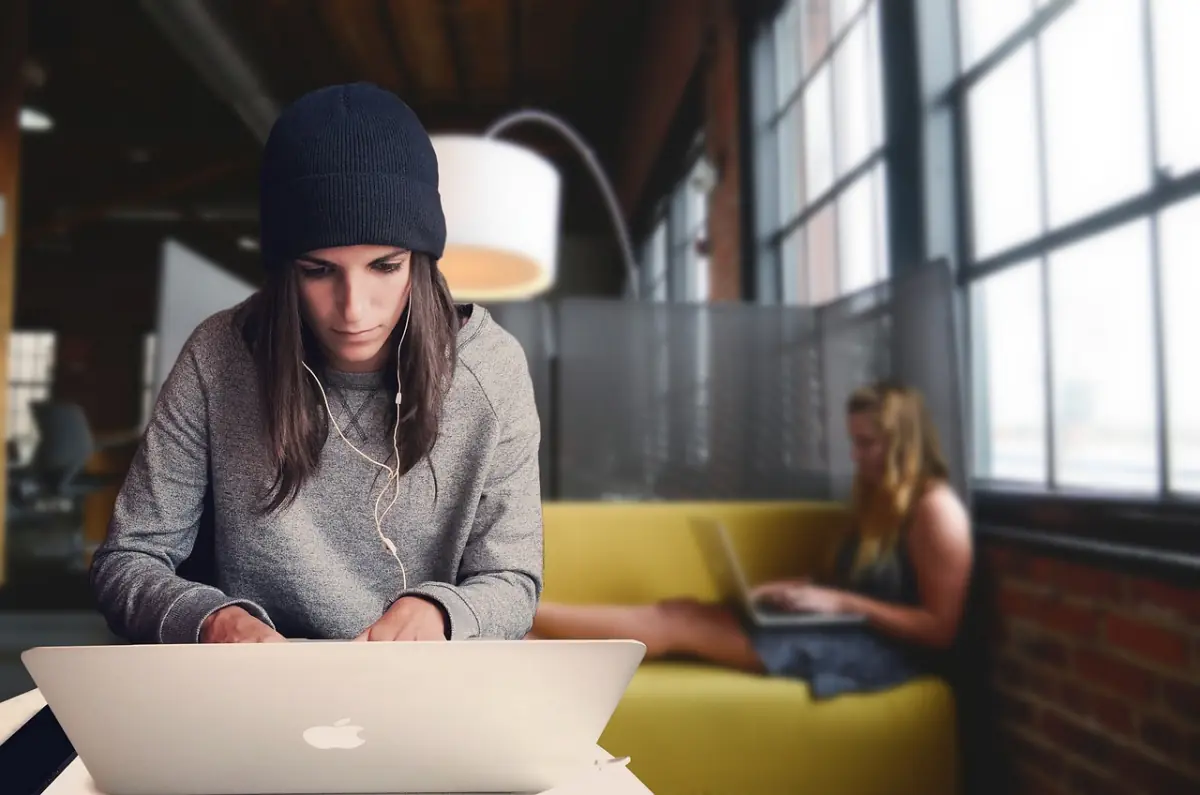 Open-Space-Büro mit mehreren Mitarbeiterinnen am Laptop – moderner Coworking-Arbeitsplatz